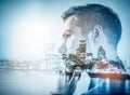 Young businessman thinking. Double exposure city background. Royalty Free Stock Photo