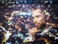 Young businessman thinking. Double exposure city background. Royalty Free Stock Photo