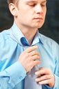 Young businessman tying a tie