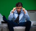 Young businessman under stress in the bedroom at night Royalty Free Stock Photo