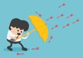 Young businessman use umbrella to protecting arrow down vector