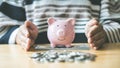 Young businessman uses both hands to protect the piggy bank, Investments or business people working in finance and accounting Royalty Free Stock Photo