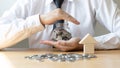 Young businessman uses both hands to protect the piggy bank, Investments or business people working in finance and accounting Royalty Free Stock Photo