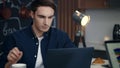 Young businessman using computer at home office. Focused man working on laptop Royalty Free Stock Photo