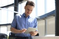 Young businessman using his tablet in the office Royalty Free Stock Photo