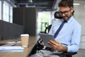 Young businessman using his tablet in the office Royalty Free Stock Photo