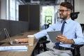 Young businessman using his tablet in the office Royalty Free Stock Photo