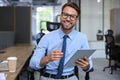 Young businessman using his tablet in the office Royalty Free Stock Photo