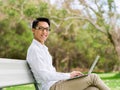 Young businessman using laptop while sitting outdoors Royalty Free Stock Photo