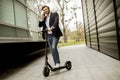 Young businessman using mobile phone  on electric scooter Royalty Free Stock Photo