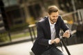 Young businessman using mobile phone  on electric scooter Royalty Free Stock Photo