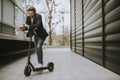 Young businessman using mobile phone  on electric scooter Royalty Free Stock Photo