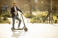 Young businessman using mobile phone  on electric scooter Royalty Free Stock Photo