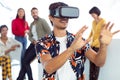 Young businessman using virtual reality headset in a modern office Royalty Free Stock Photo