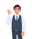 Young businessman in waistcoat showing okay or OK gesture. Person making symbol of agree, good or cool sign. Male character design