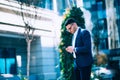Young businessman is walking around and talking on his phone at the city financial center Royalty Free Stock Photo