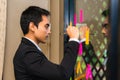 Young businessman wear suit writing business ideas on paper post it Royalty Free Stock Photo