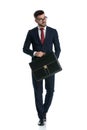 Businessman walking with briefcase and looking away cool Royalty Free Stock Photo