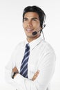 Young businessman wearing headset with arms crossed. Conceptual image Royalty Free Stock Photo