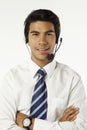 Young businessman wearing headset with arms crossed. Conceptual image Royalty Free Stock Photo