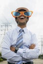 Young businessman wearing oversized sunglasses. Conceptual image