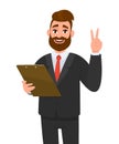 Young businessman wearing a suit holding clipboard and making or showing victory, V, peace, two gesture with hand finger. Person Royalty Free Stock Photo