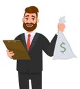 Young businessman wearing a suit holding clipboard and showing money, cash, currency notes bag with dollar sign.
