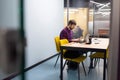 Young businessman working at his desk in the office on a laptop. Business, co-working, online training. Side view Royalty Free Stock Photo