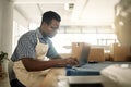 Young businessman working on his laptop. African American tailor sending an email. Professional designer working online Royalty Free Stock Photo