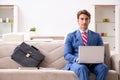 The young businessman working at home sitting on the sofa Royalty Free Stock Photo