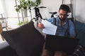 Young businessman working on laptop computer while sitting on sofa at home Royalty Free Stock Photo