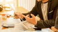 A young businessman working at an office with a laptop and graphing documents on the desk. The concept of a lawyer, consultant,