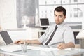 Young businessman working in office using laptop Royalty Free Stock Photo