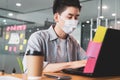 Young businessman working in office wearing protective mask for covid19 protection corona flu prevent healty ideas concept office Royalty Free Stock Photo