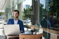 Young businessman working outside at a cafe table Royalty Free Stock Photo