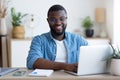 Young businessman working with pleasure on his laptop in office Royalty Free Stock Photo