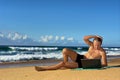 Young businessman works with notebook on beach