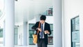 Young businessman worried looking at his wrist watch Royalty Free Stock Photo