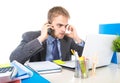 Young businessman worried tired talking on mobile phone in office suffering stress Royalty Free Stock Photo