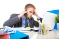 Young businessman worried tired talking on mobile phone in office suffering stress Royalty Free Stock Photo