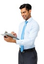 Young Businessman Writing On Clipboard Royalty Free Stock Photo