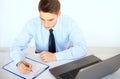 Young businessman writing on clipboard Royalty Free Stock Photo