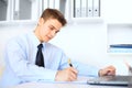 Young businessman writing on clipboard Royalty Free Stock Photo