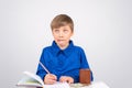 Young businessman Young smart boy enthusiastically writes in a N