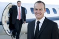 Young businessmen in front of corporate jet Royalty Free Stock Photo