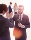 Young businessmen giving each other high five.