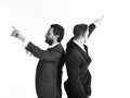 Young businessmen pointing in two different directions at same t Royalty Free Stock Photo