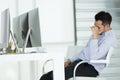 Young businessmen in stress. Sit in front of modern office computer, concept for hard work in an organization. Royalty Free Stock Photo