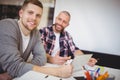 Young businessmen using digital tablet at desk in office Royalty Free Stock Photo