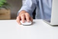 Young businessmen are using a mouse on a white desk to work at home. Close up of the hand Royalty Free Stock Photo